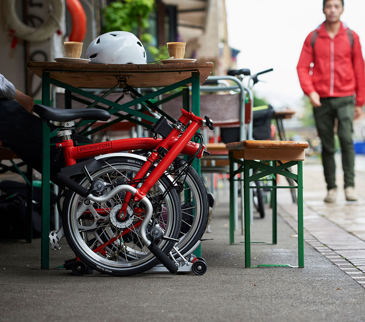 Brompton bike folded next to table