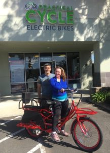 Lori Brentt on her Red Pedego Stretch electric cargo bike