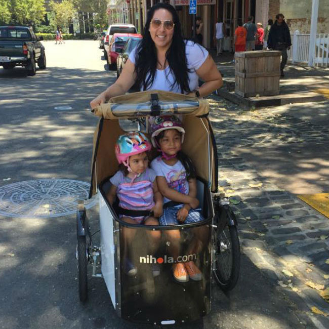 Mother and two kids in nihola bike